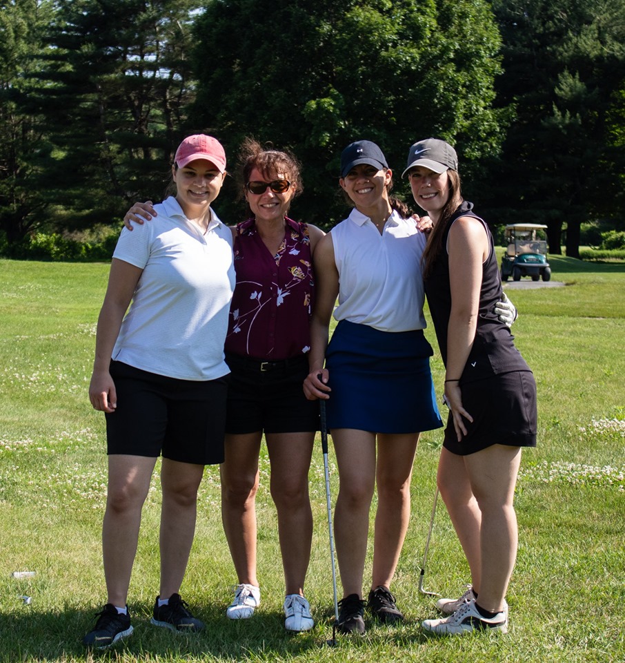 Female Foursome of Golfers taking picture together on course